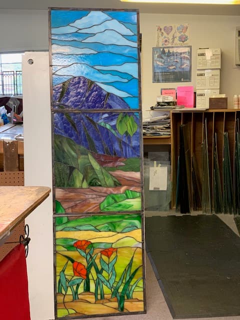Tall stained glass triptych — mountain landscape with California poppies