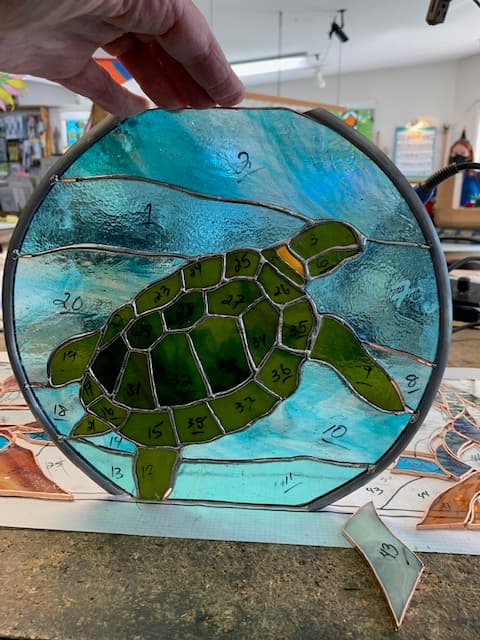 Round stained glass sea turtle suncatcher in greens and teal