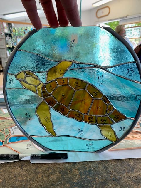 Round stained glass sea turtle suncatcher in gold and amber