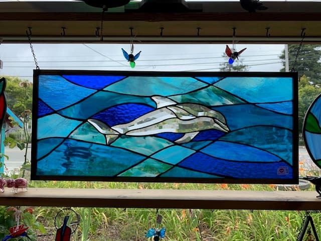 Stained glass dolphin panel in blues and teals