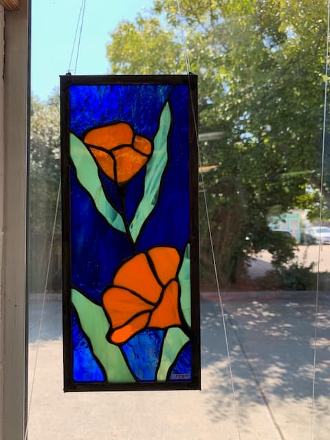 California poppies stained glass panel — orange blooms on cobalt blue