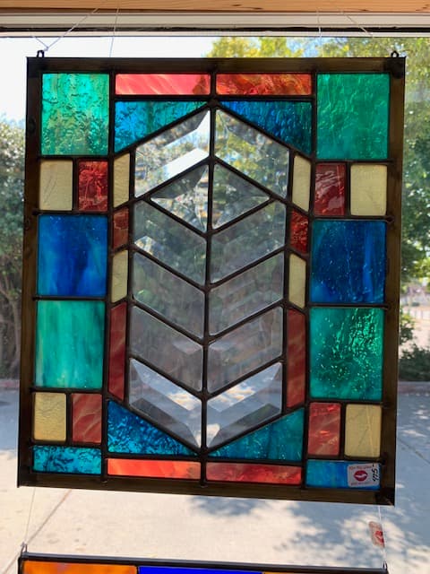 Geometric beveled glass panel with teal, red, and orange border
