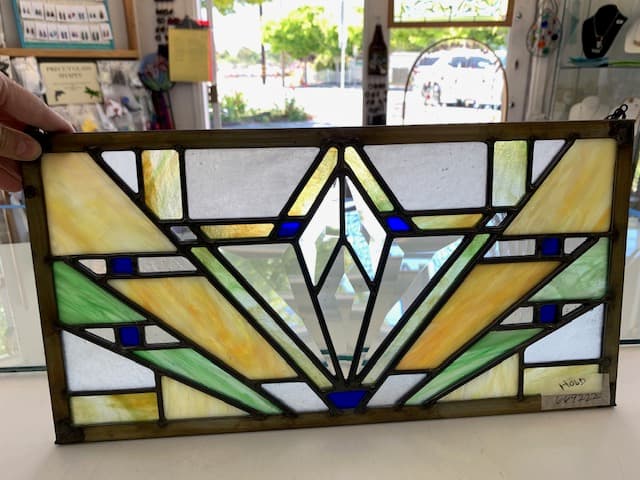 Art Deco stained glass panel with geometric sunburst in yellow and green