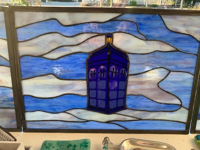 Stained glass TARDIS panel in blue and purple clouds